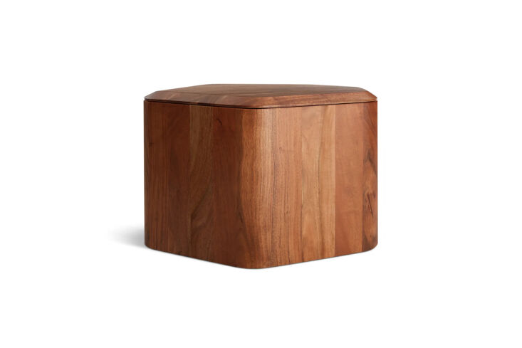 An acacia wood side table with its beveled top removed to show a deep storage cavity.
