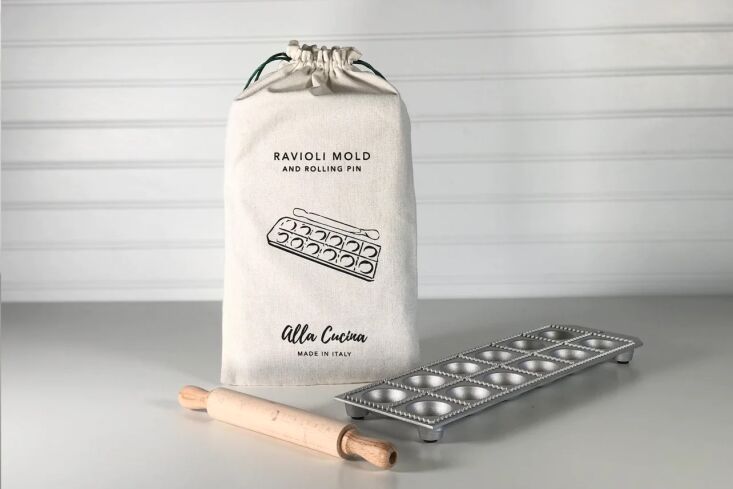 A 12-piece aluminum ravioli mold paired with a small beechwood rolling pin.