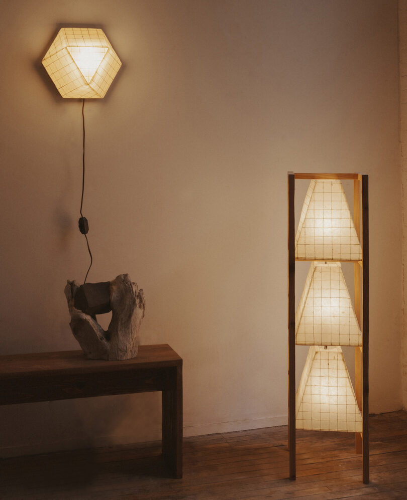 A variety of hexagonal and pyramid-shaped SAW.Earth paper lamps illuminating a minimalist room.