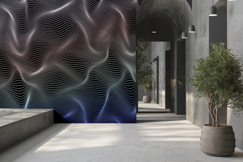 A modern concrete hallway featuring a large-scale colorful wavy mural that creates a sense of movement.