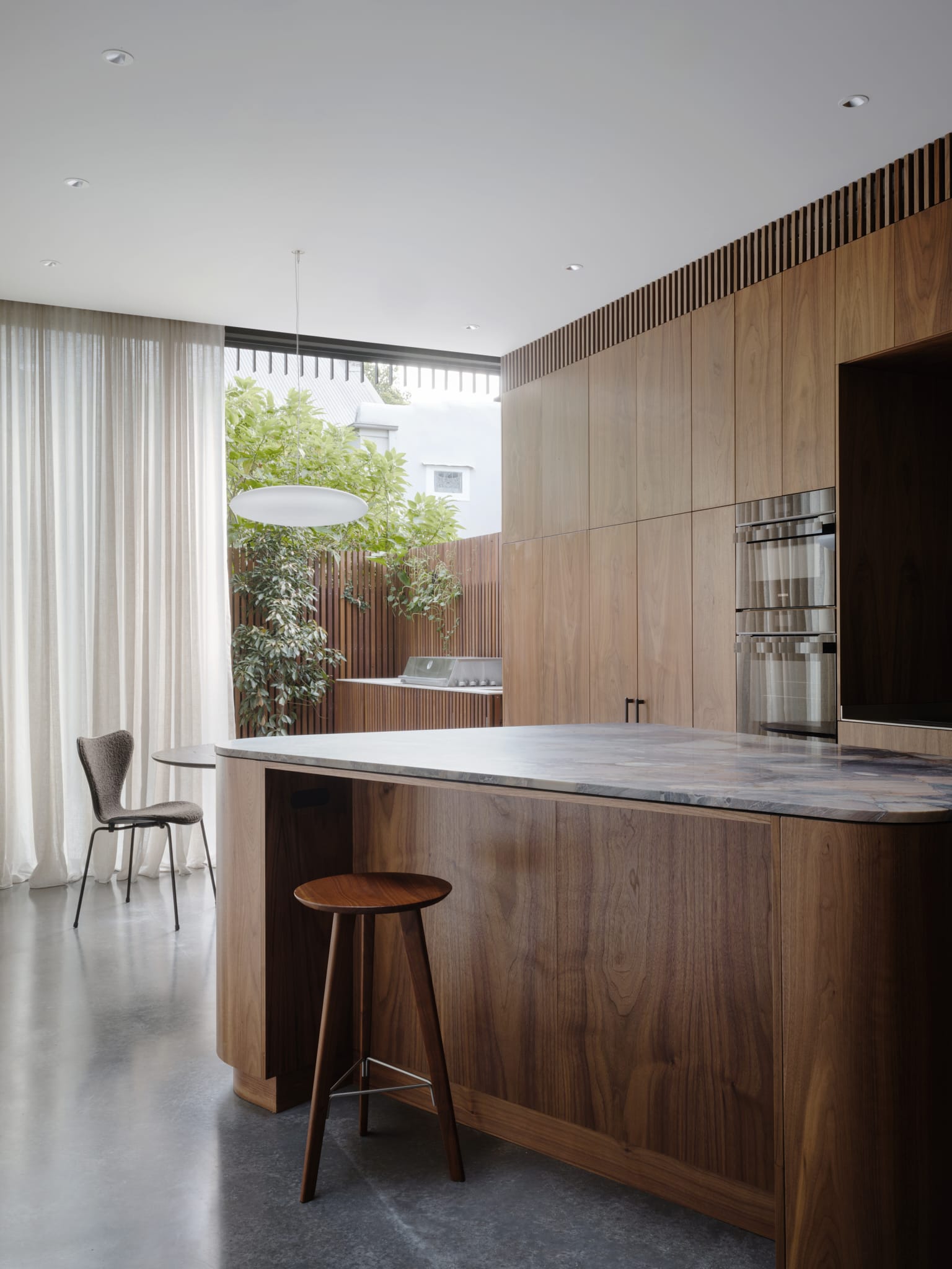 Architectural staircase design with timber accents and natural light coming from above.