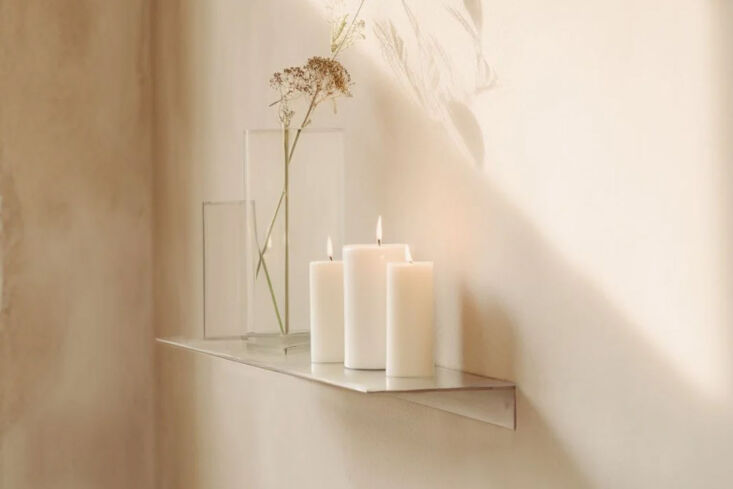 Industrial forged steel linear floating shelf with a gold powder-coated finish.