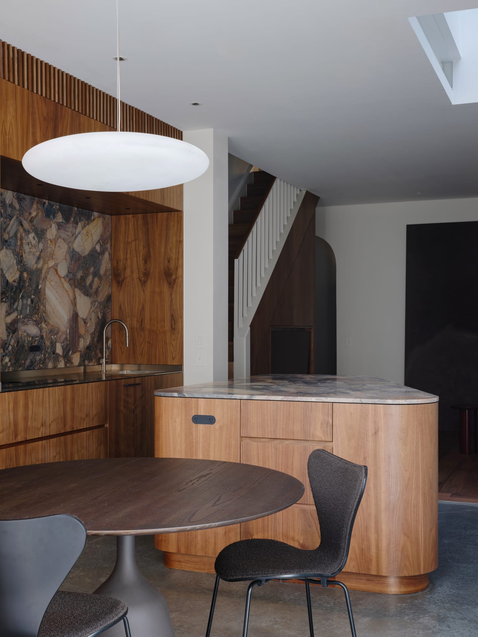 Hallway view featuring custom built-in storage and seamless timber wall panels.