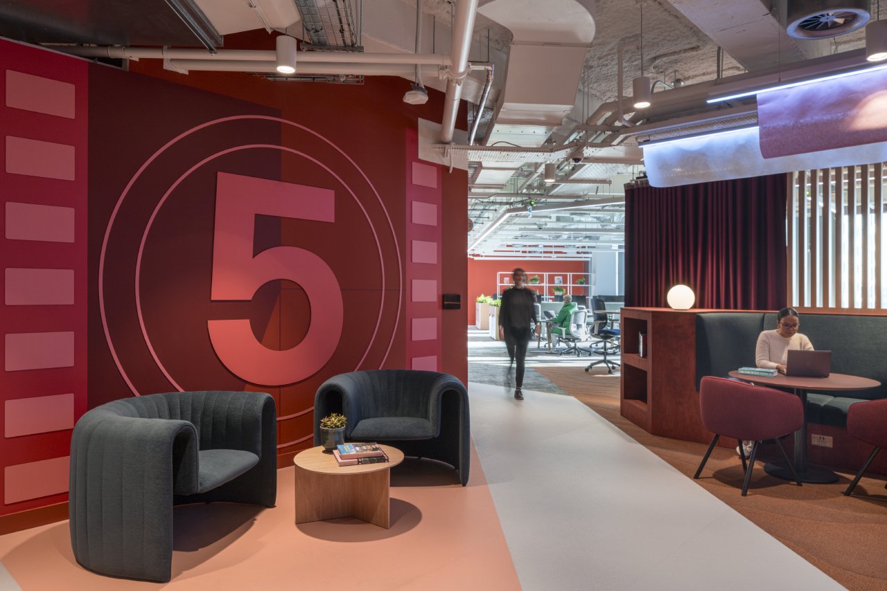A wide interior view of the Virgin Media O2 London headquarters showing a spacious, multi-level layout.