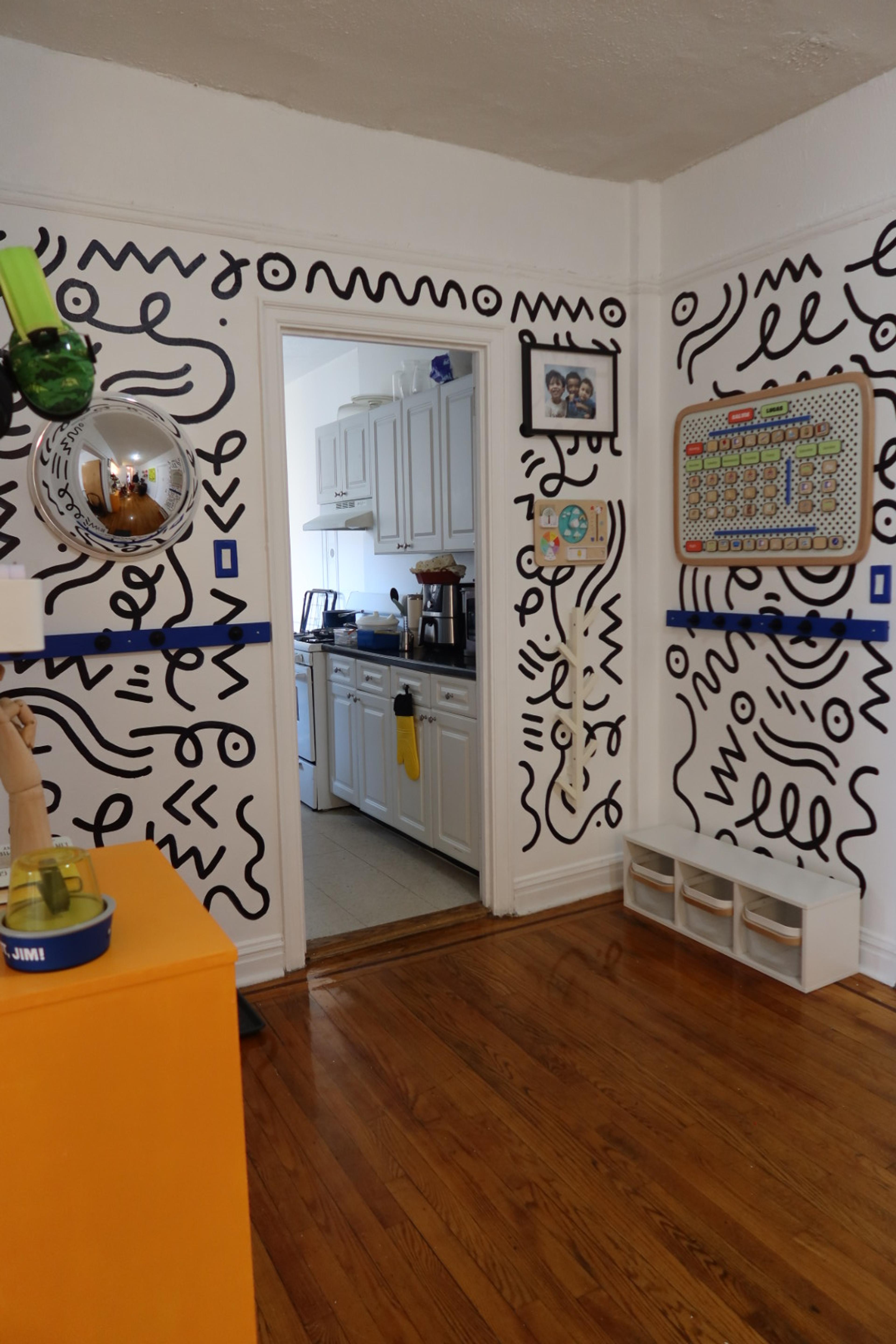 A transformed, tidy entryway with designated spots for children's belongings.
