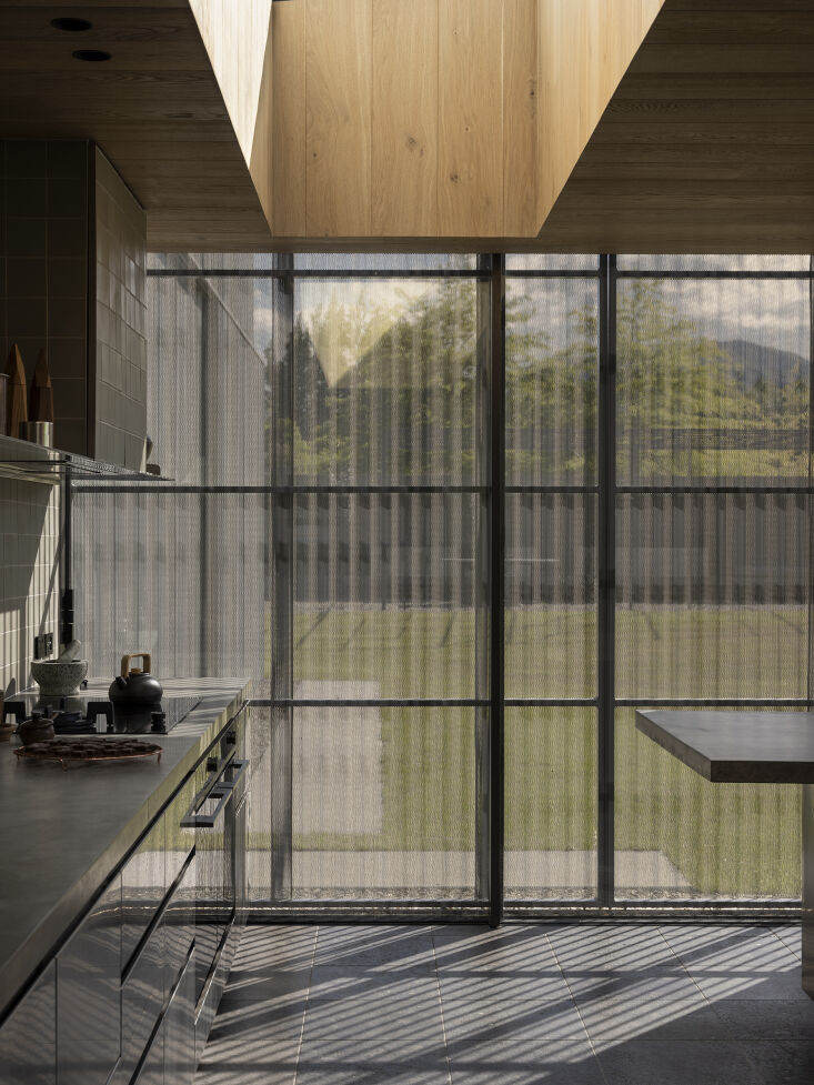 Close-up of perforated corrugated metal panels used for light filtration and ventilation.