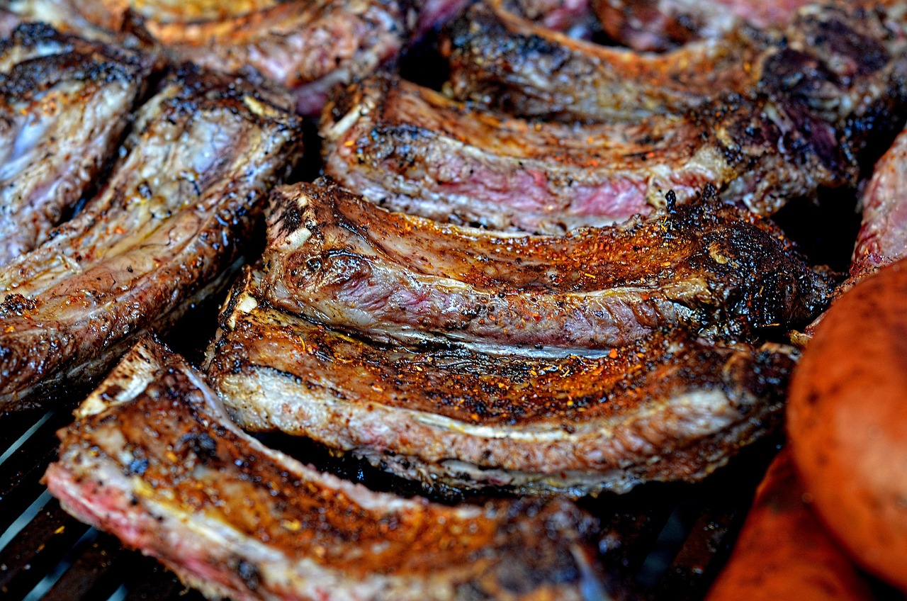 Slow-smoked beef ribs with a dark seasoning bark and smoke ring
