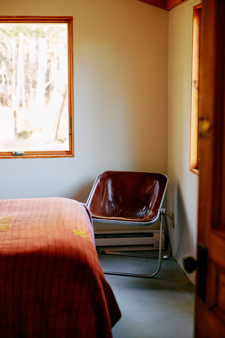 A neutral-toned guest room with furniture sourced from auctions and Etsy.