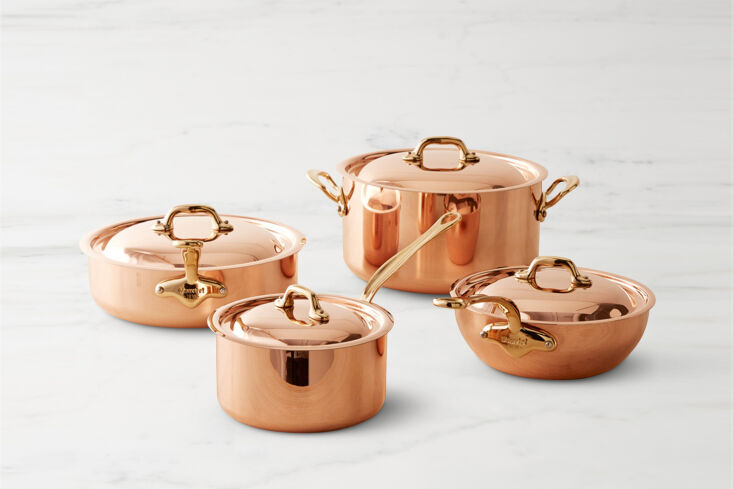 Mauviel 8-piece copper cookware set with stainless steel interiors and professional handles.