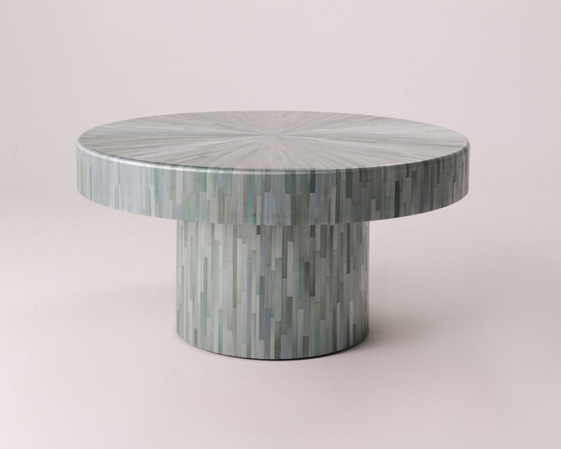 A low-angle shot of the round coffee table emphasizing its thick top and sturdy cylindrical base.