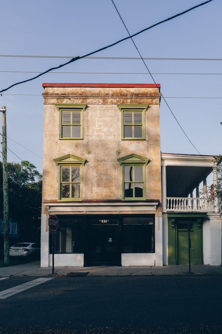 Exterior view of a historic Federal-style townhouse in downtown Charleston with Gothic influences.