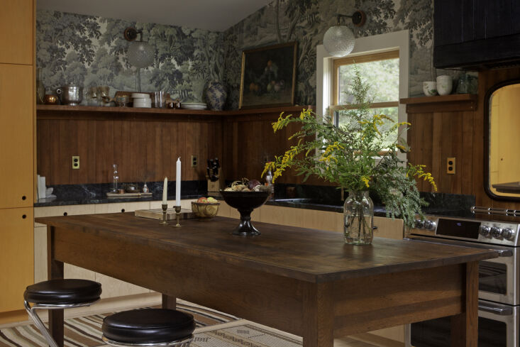 A kitchen backsplash made from reclaimed heart pine wood panels.