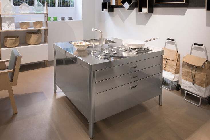 Alpes Inox stainless steel island unit with sink and cooktop.