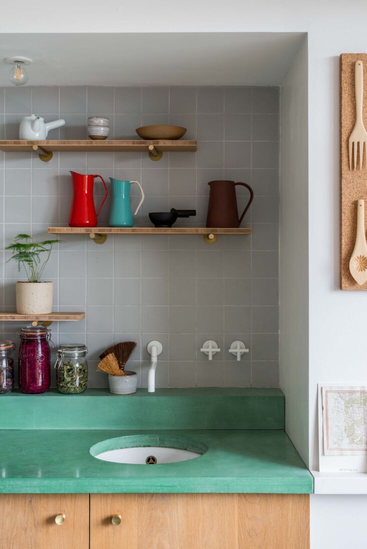 Vintage Dansk pitchers adding a pop of color to a bright, modern kitchen space.