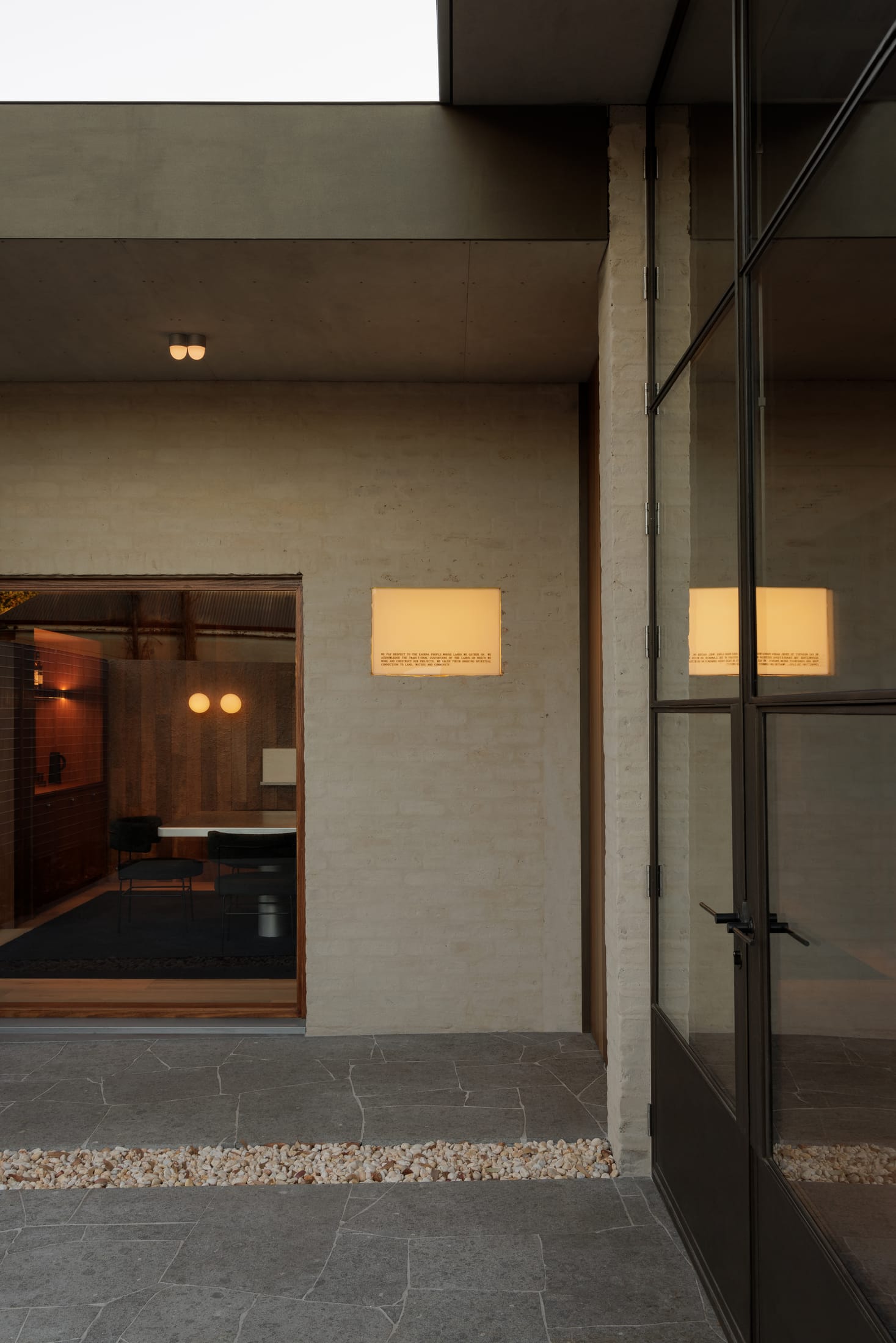 Interior view of the Brompton Studio showing exposed concrete block walls and steel trusses.