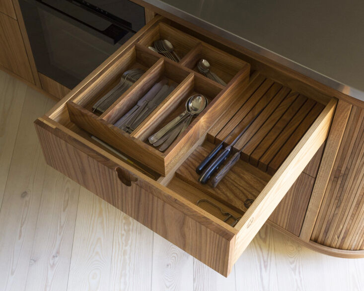 Close-up of a custom-made elm wood drawer showing precision joinery and vertical annual rings.