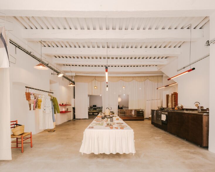 A white custom curtain with cutout doors separating an office area from a showroom.