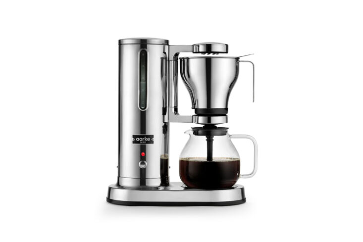 Aarke Drip Coffee Maker with a clear glass carafe and a visible stainless steel water reservoir.