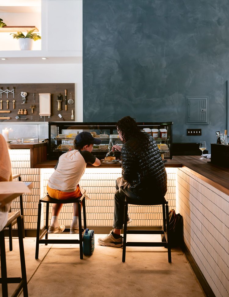 A collection of kitchen utensils organized as a wall display in a restaurant.