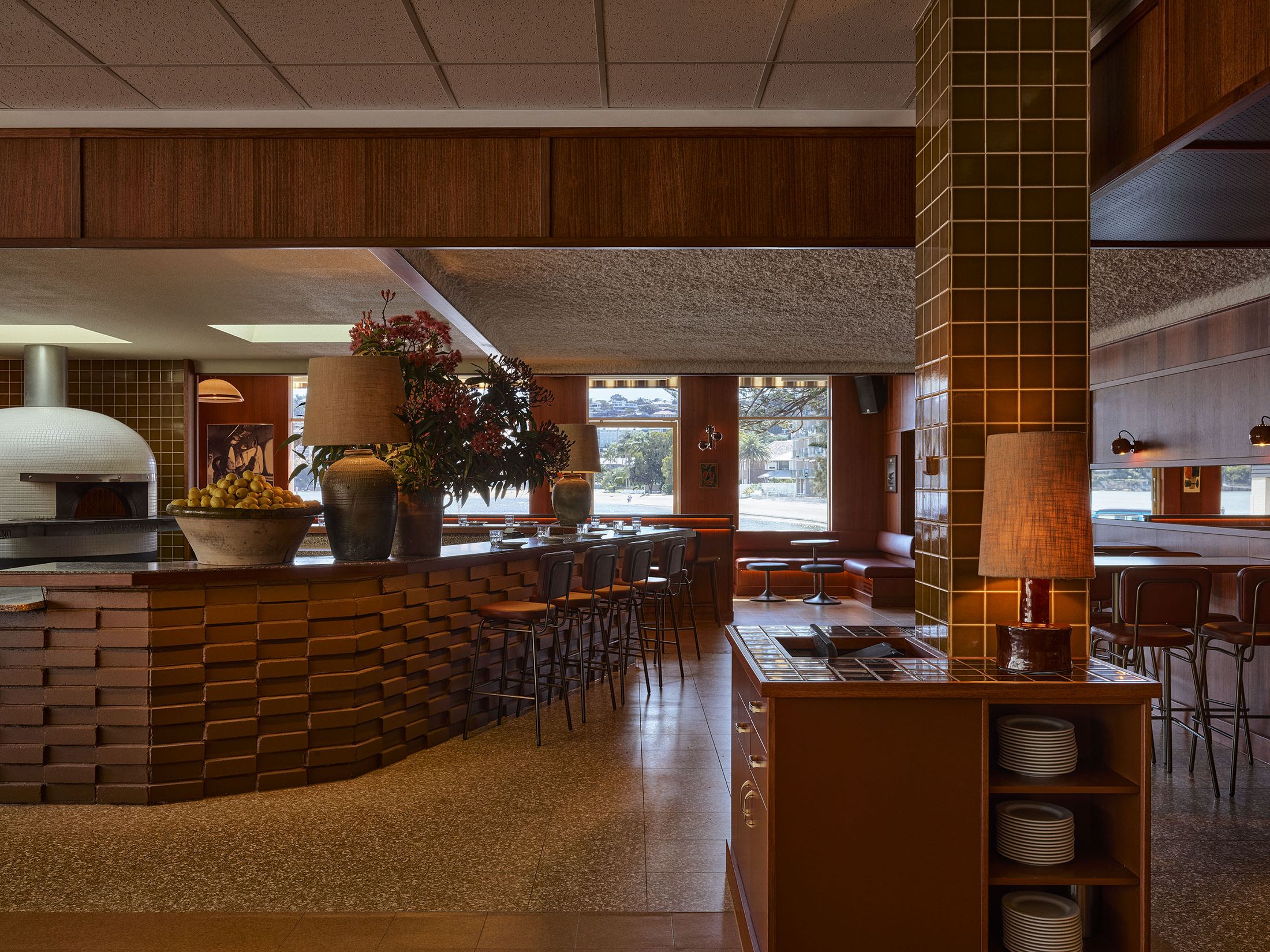 Exterior shot of Club Rose Bay showing transitions between indoor and outdoor social zones.