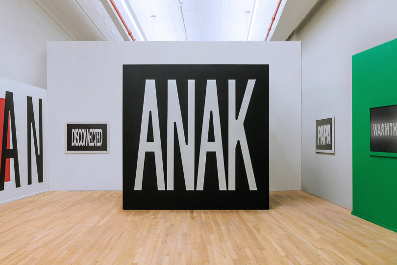 Gallery view of the Human Response exhibit with a large box reading 'ANAK'.