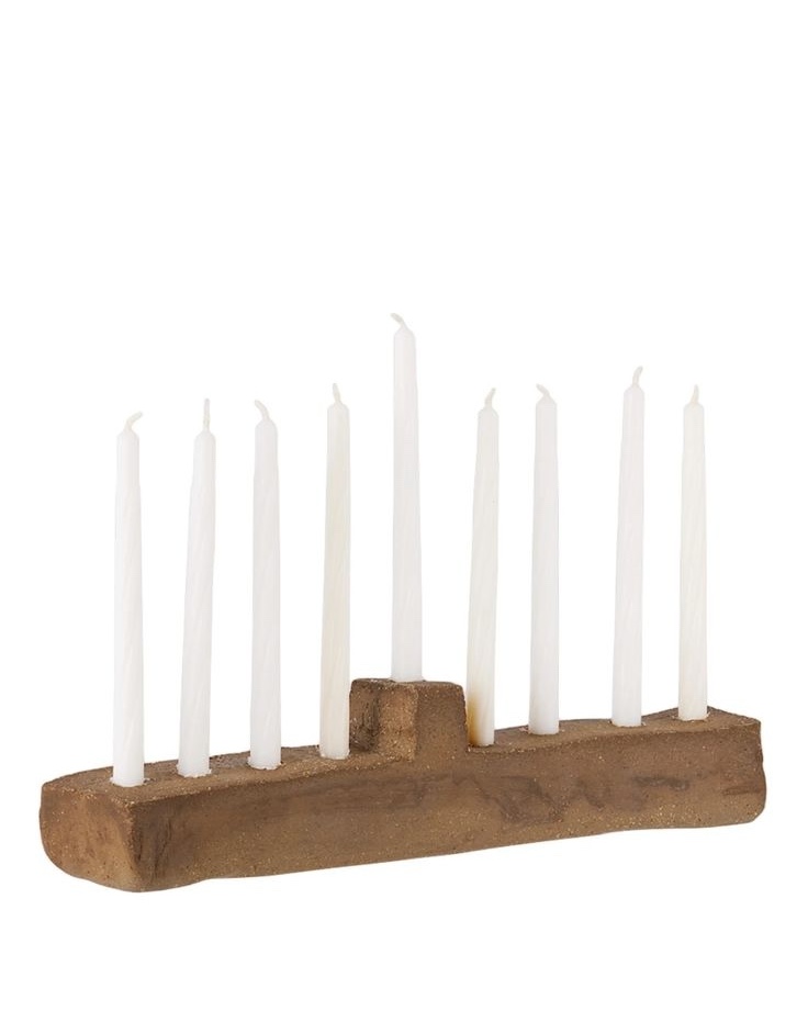 A minimalist wood-fired stoneware menorah with a natural, earthy texture and a slight soda kiln glaze.
