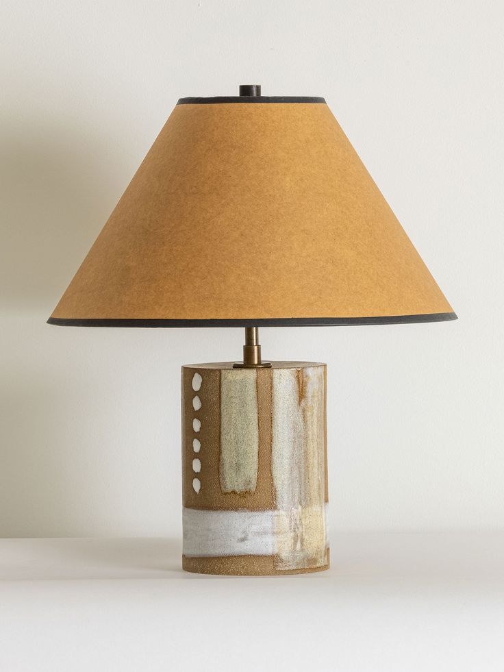A stoneware table lamp featuring slab construction and a textured finish.