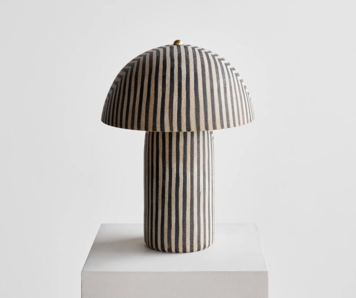 A tall, architectural striped ceramic lamp by Ceramicah.