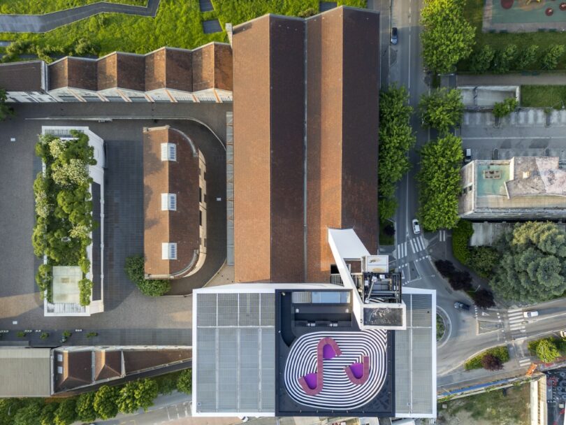 Aerial view of the Fondazione Prada rooftop featuring black and white concentric patterns and modular seating.