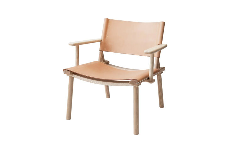 A Nikari December Lounge Chair in light ash wood with a thin vegetable-tanned leather sling.