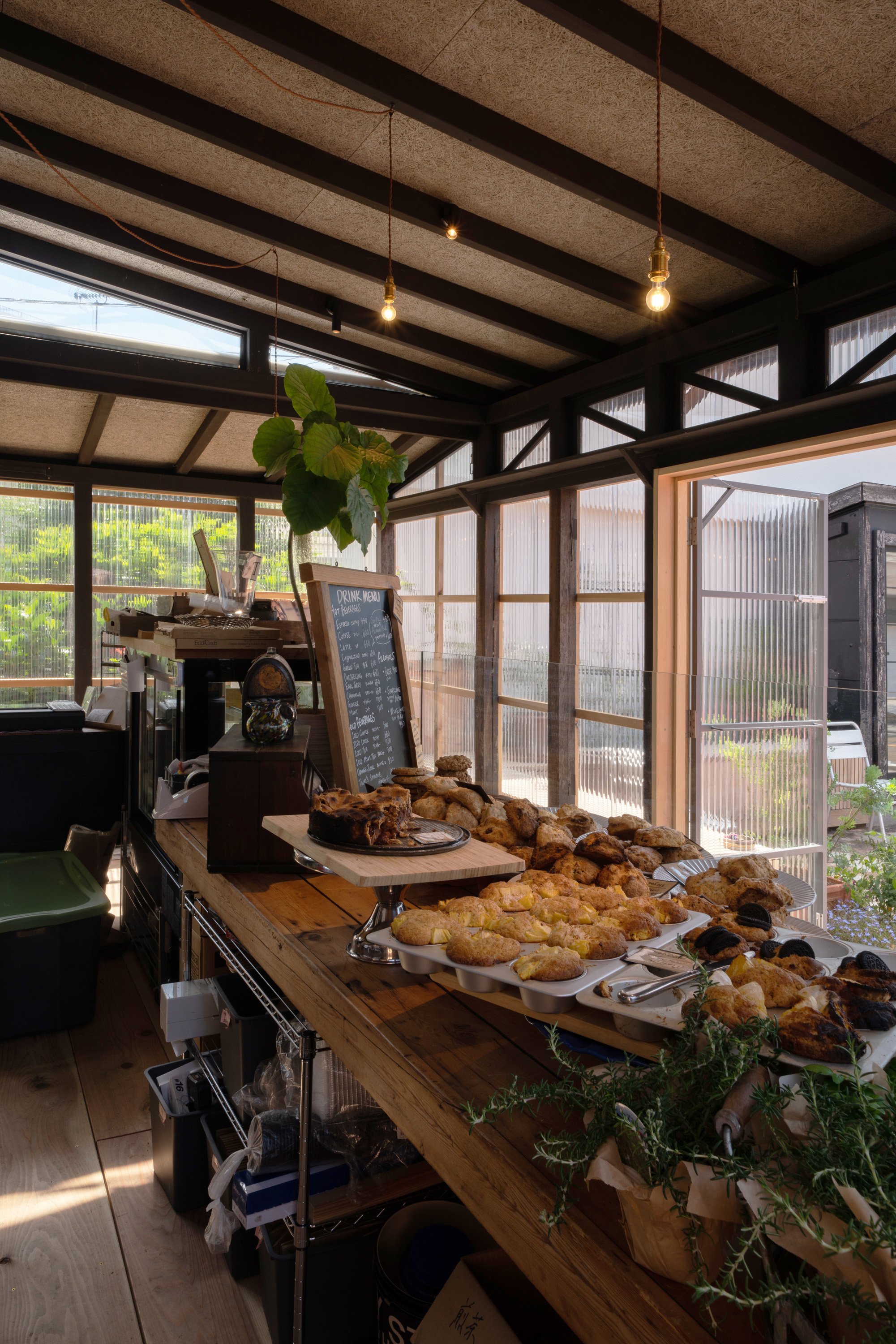 Detailed view of exposed wooden ceiling beams and textured wood-fiber cement block insulation.