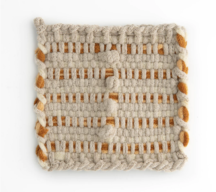 A sophisticated hand-woven potholder in muted tones of flax, apricot, and rust.