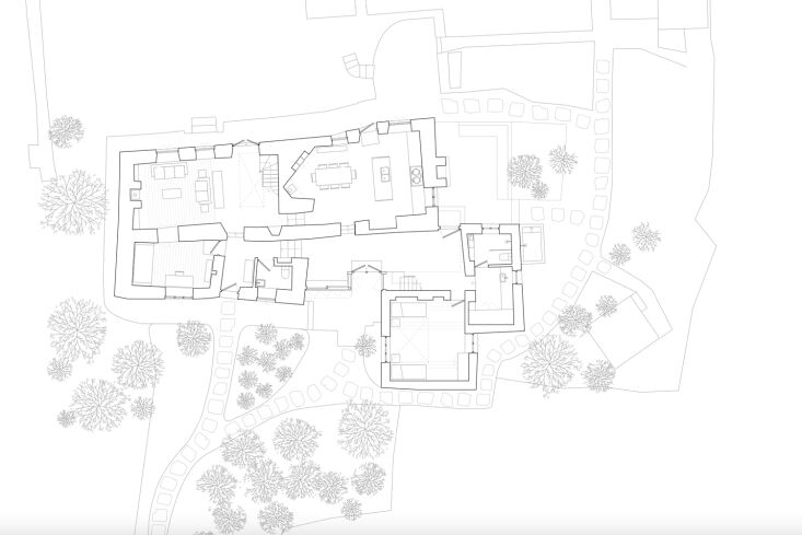 A black and white architectural floor plan of the ground floor showing the original structure and the new addition.