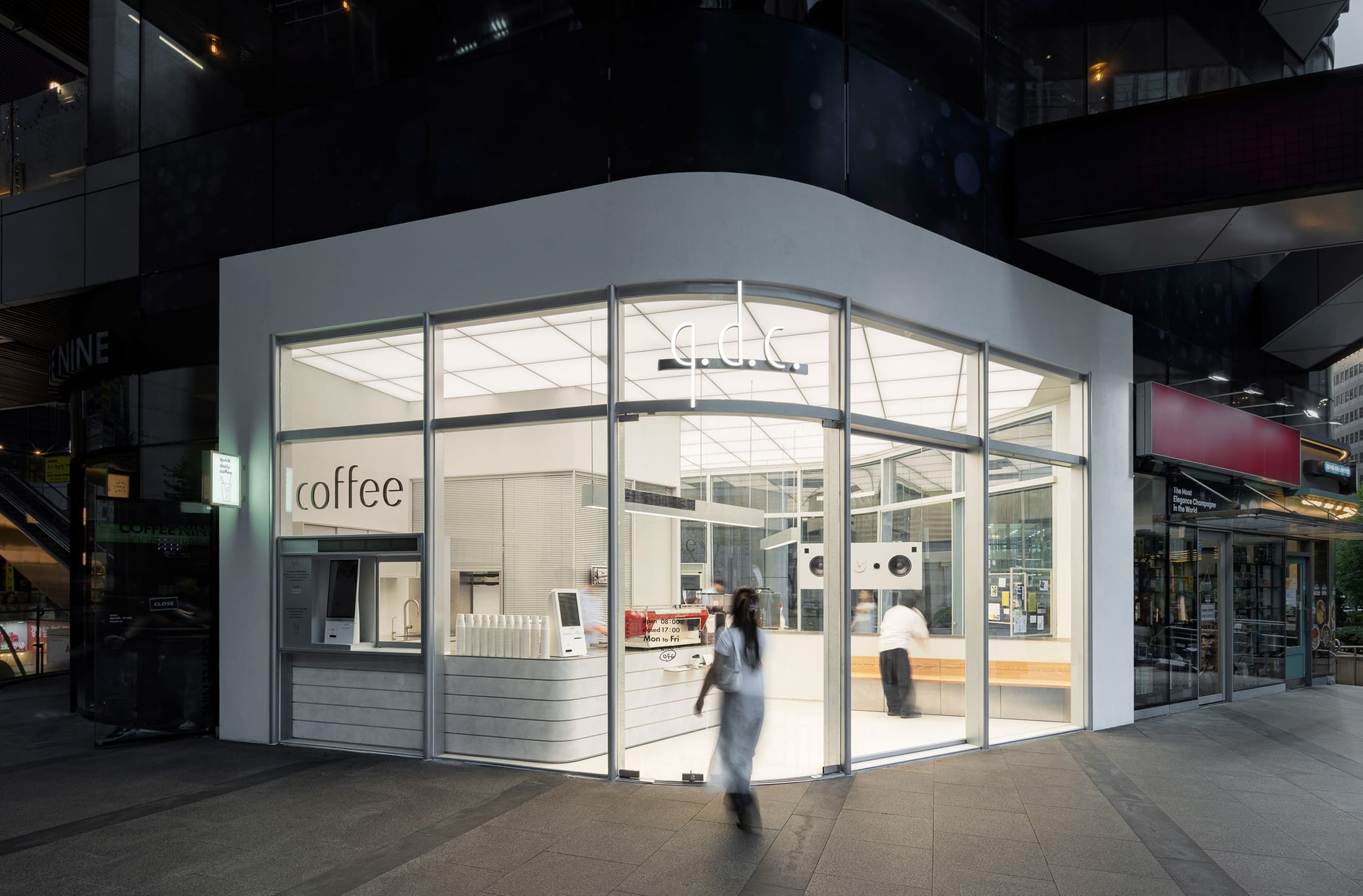 View from the outside looking into the glowing interior of the cafe at dusk.