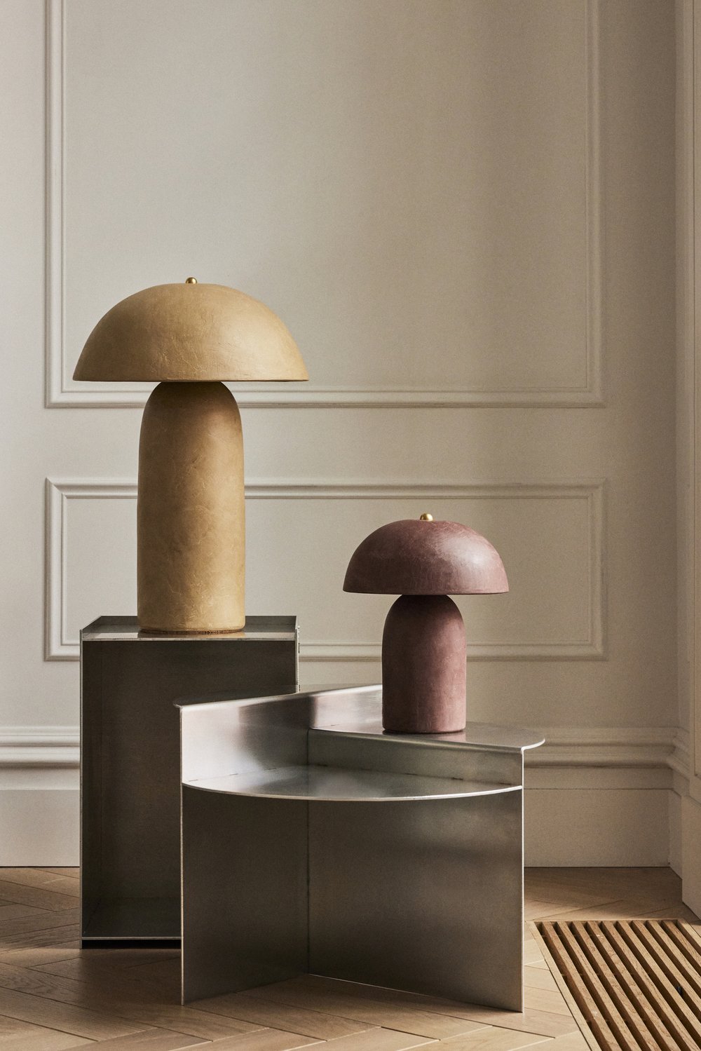 Sleek silver home decor items with soft, organic shapes.