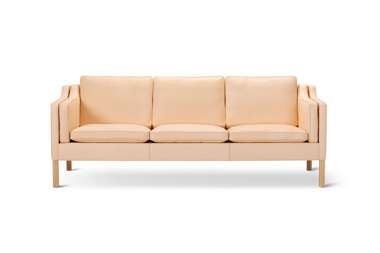 A vintage-style Børge Mogensen 2213 three-seat leather sofa in a bright room.