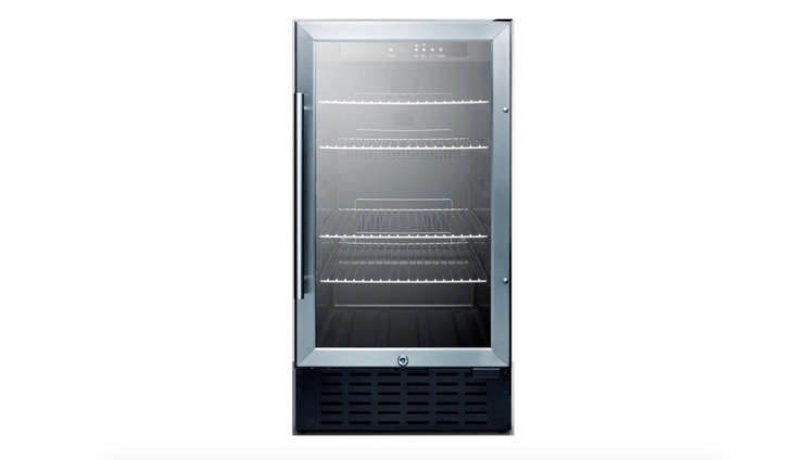 A sleek black under-counter beverage cooler tucked into custom cabinetry.