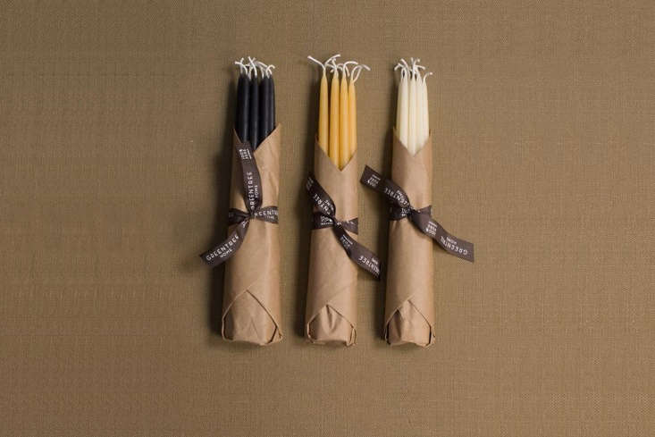 A variety of colorful taper candles neatly packaged.