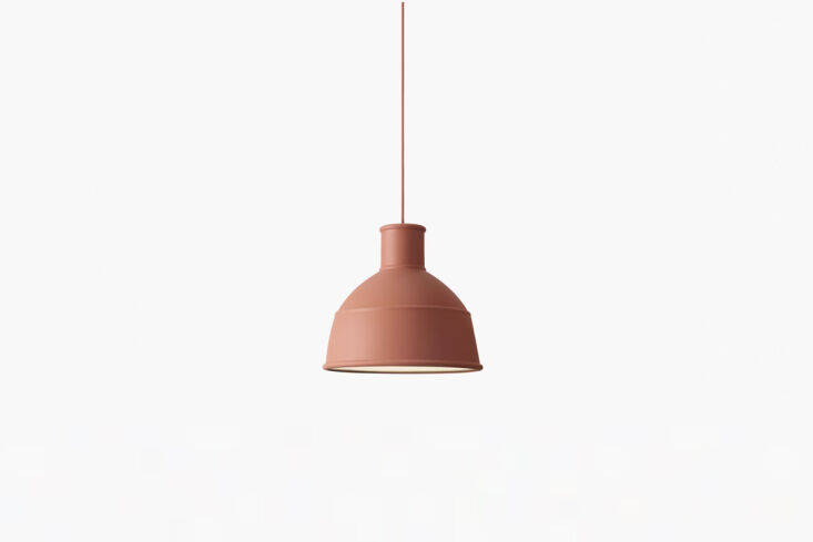 Custom terracotta pendant light hanging over a timber kitchen counter.