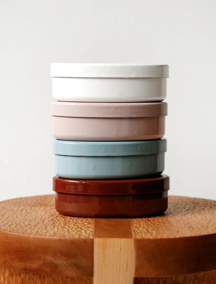 Four Classiky enamel bento boxes in different colors showing their glossy finish and small 6 by 3.75 inch size.