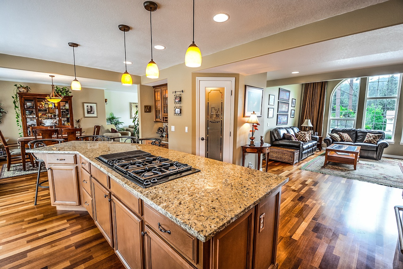 A close-up view of the vertical space between a kitchen countertop and upper wooden cabinets.