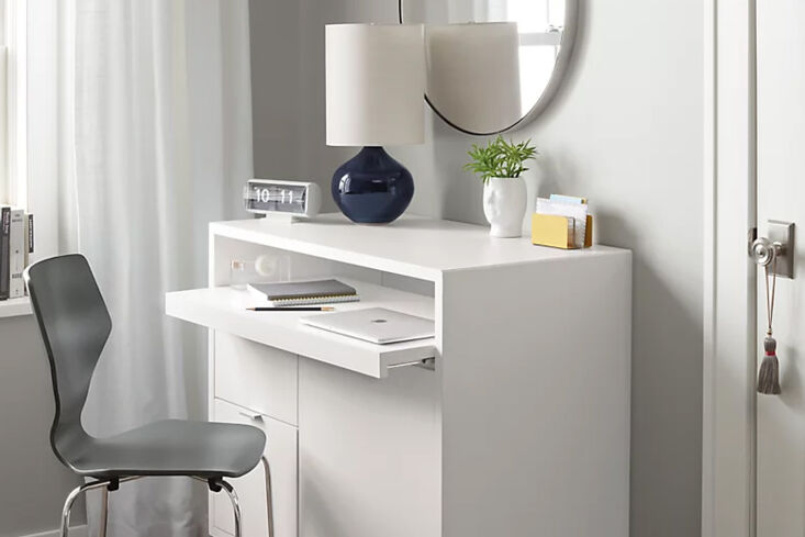 Tall wood office cabinet with a pull-out desktop surface.