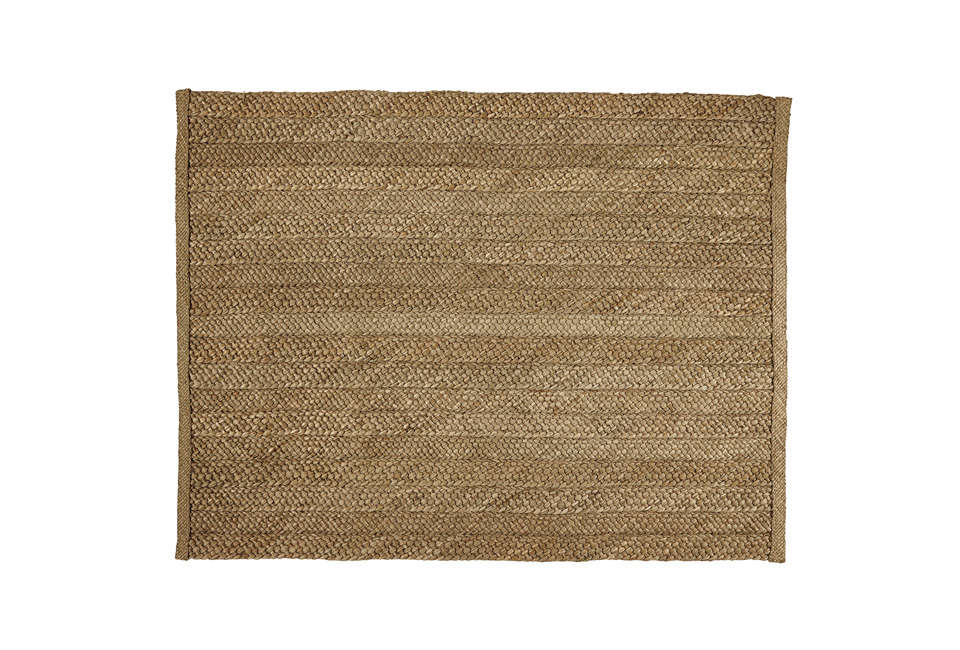 Natural rush matting on a bedroom floor providing organic texture.