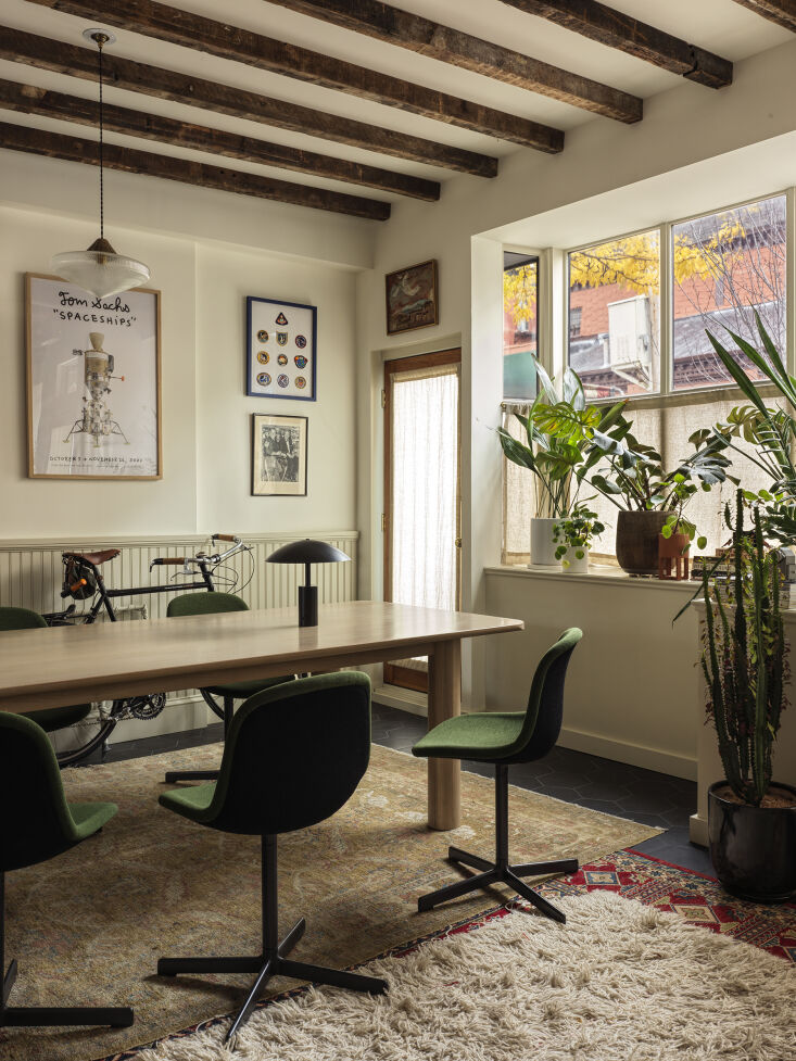 Meeting area with a large table, Hay Neu 10 chairs, and Holophane pendant lights.