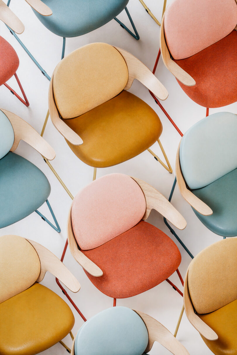 Overhead view of multiple pastel-colored Mysa chairs arranged in a geometric pattern.