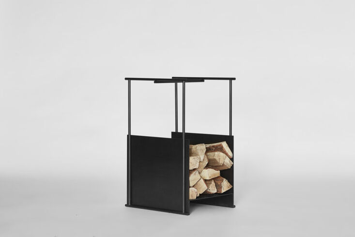 High-end Black Firewood Hutch with an oiled brass frame.