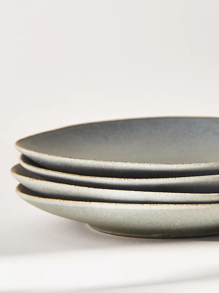 Minimalist stoneware dinner plates in a soft mist-green color with a matte finish.