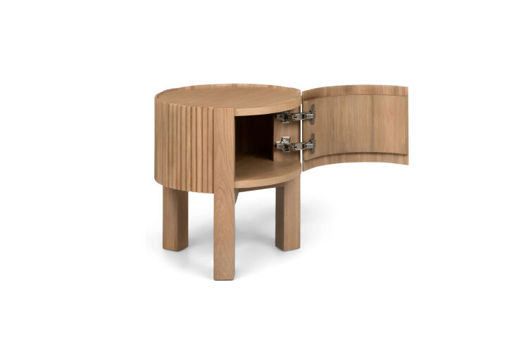 A round oak side table with a fluted wood design and a side door.
