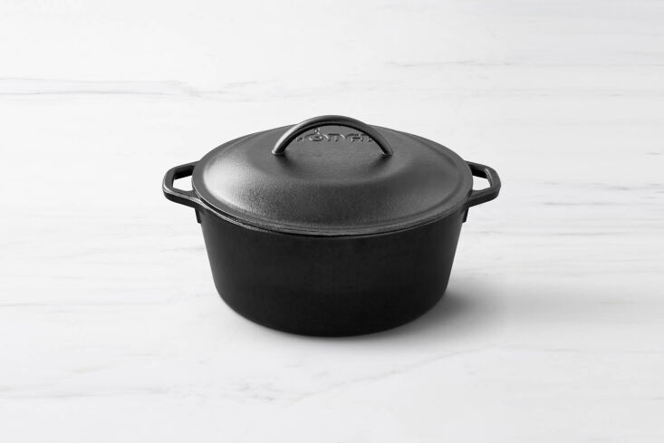 A seasoned black Lodge cast iron Dutch oven with a classic lid.