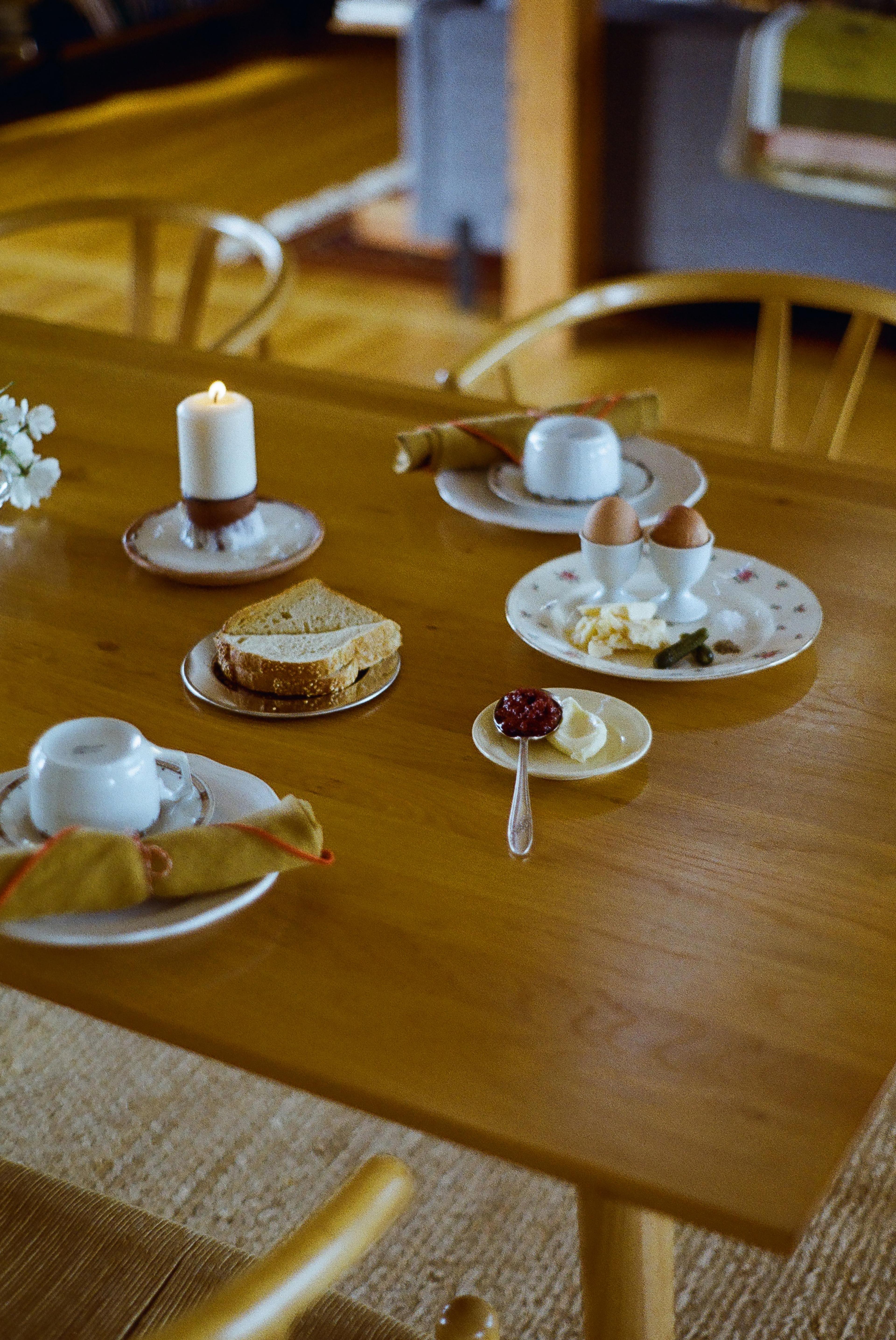 A breakfast table set with fresh coffee and artisanal food inside the inn.
